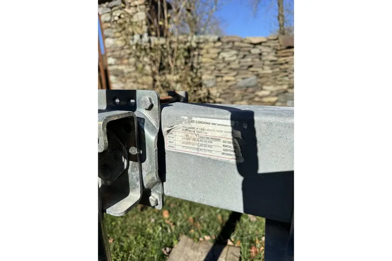 Slide: The Image of Close-up of a metal component with a label, outdoors, Regulator 24 Forward Seating, 2004. - 6