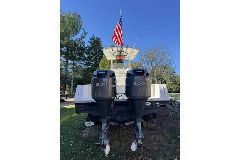 Slide: The Image of 2004 Regulator 24 Forward Seating boat with dual Yamaha 200 engines, American flag displayed. - 9