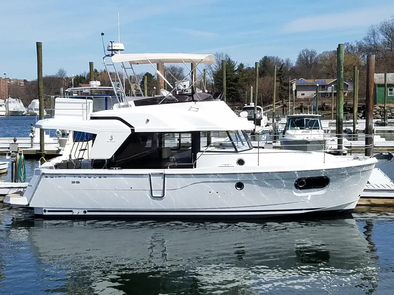The Image of 2019 Beneteau Swift Trawler 35 docked in a marina, showcasing sleek design and modern features. - 0