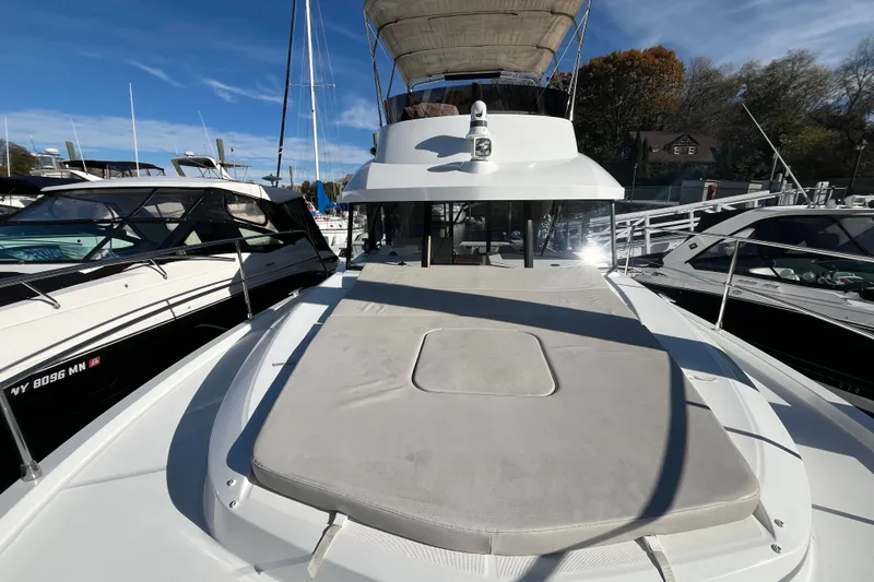 Slide: The Image of 2019 Beneteau Swift Trawler 35 docked, showcasing spacious deck and flybridge. - 17