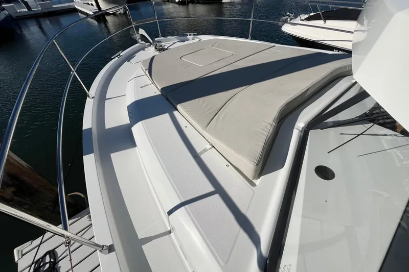 Slide: The Image of 2019 Beneteau Swift Trawler 35 deck with sunpad, docked at marina. - 18