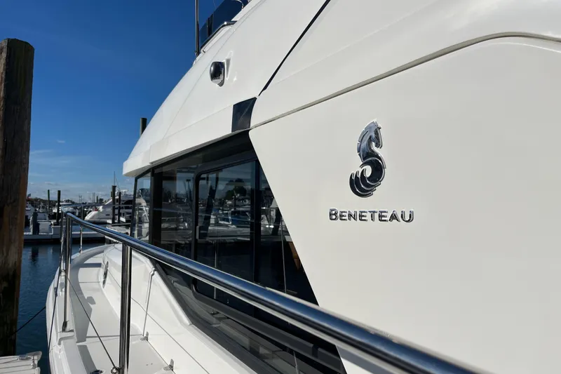 Slide: The Image of 2019 Beneteau Swift Trawler 35 docked, showcasing sleek design and logo. - 19