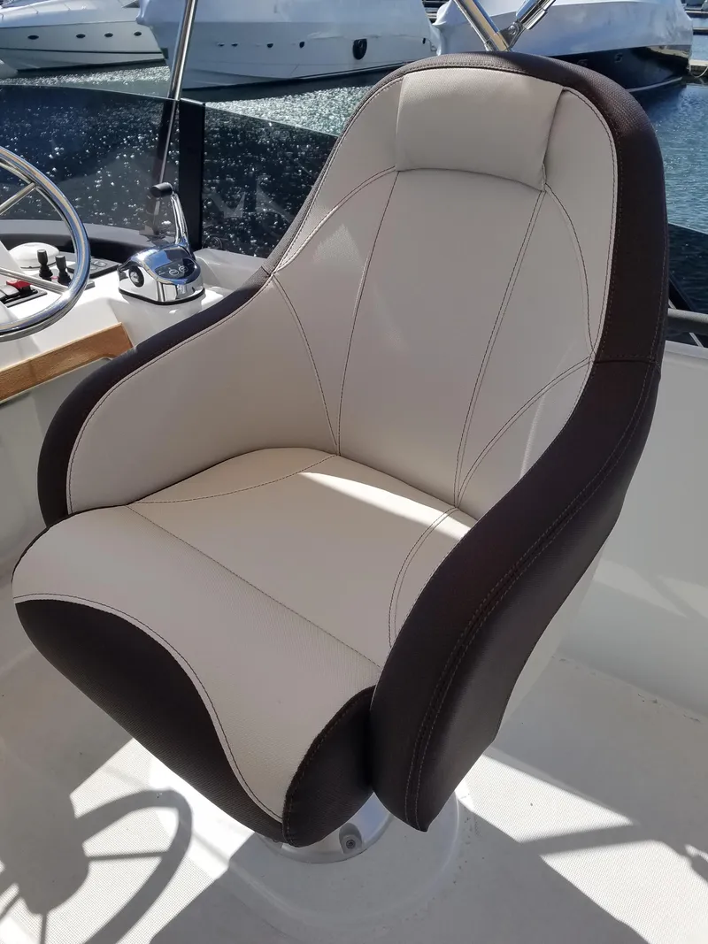 Slide: The Image of Captain's chair on 2019 Beneteau Swift Trawler 35, featuring sleek design and comfortable upholstery. - 26