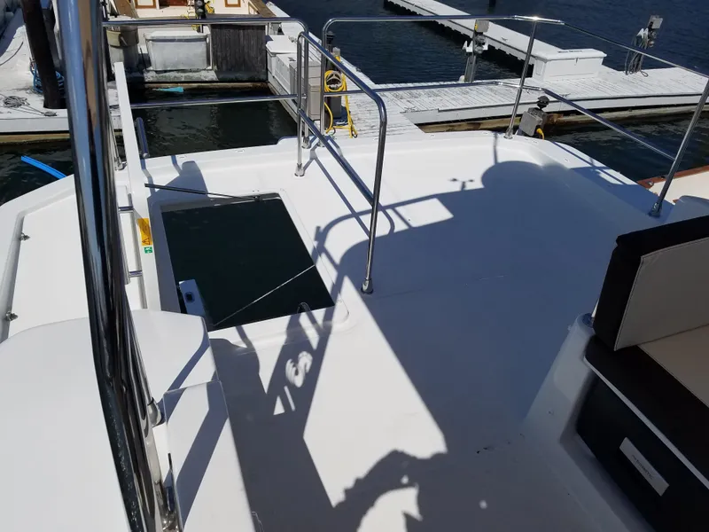 Slide: The Image of 2019 Beneteau Swift Trawler 35 deck with railings, docked at marina. - 27