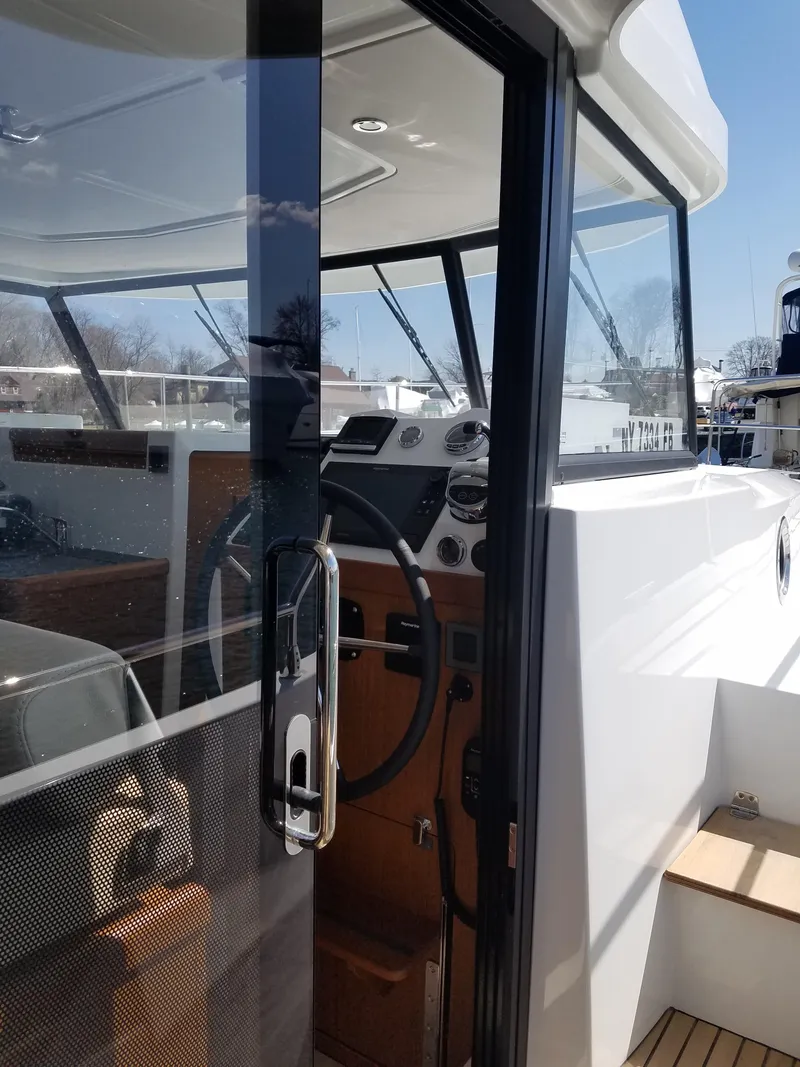 Slide: The Image of 2019 Beneteau Swift Trawler 35 cockpit with modern controls and sleek design. - 29