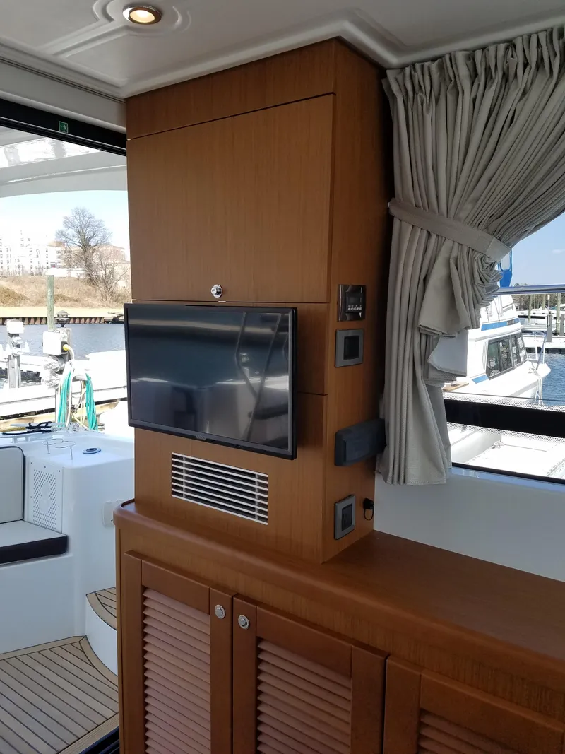 Slide: The Image of Interior of 2019 Beneteau Swift Trawler 35 with wood paneling and mounted TV. - 32