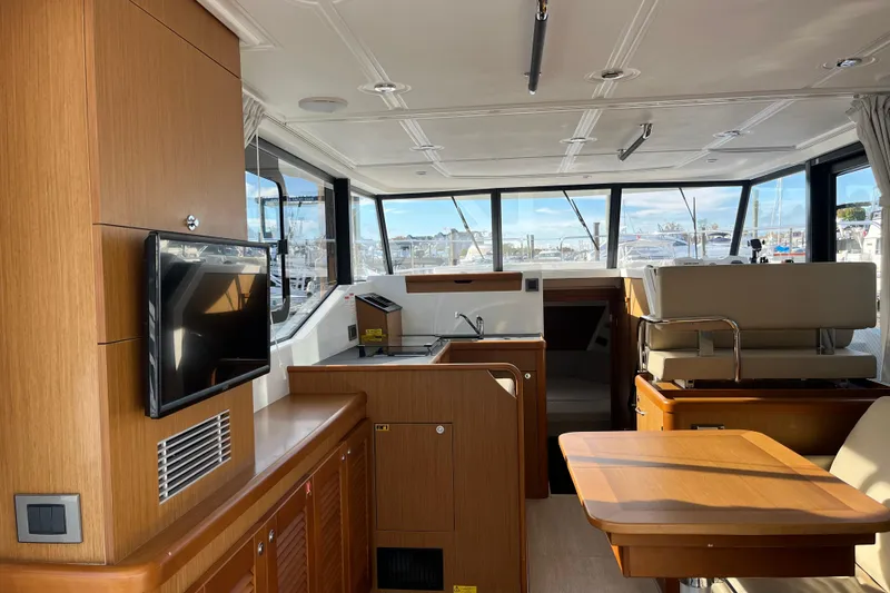 Slide: The Image of Interior of 2019 Beneteau Swift Trawler 35 with modern wood finish and large windows. - 33