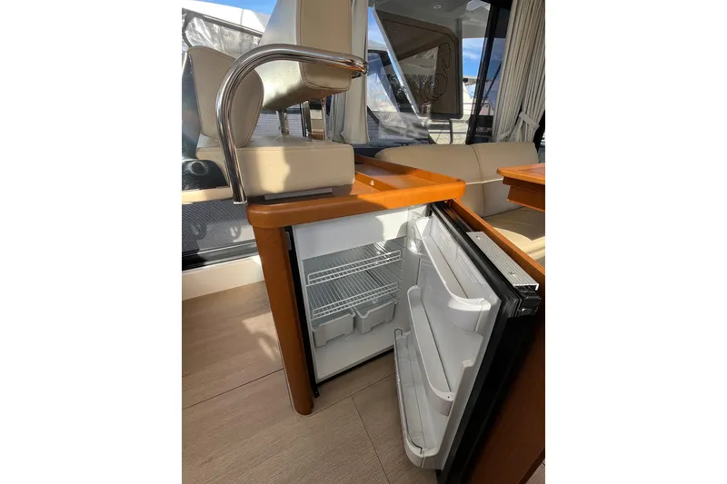 Slide: The Image of Interior of 2019 Beneteau Swift Trawler 35 with open mini fridge and seating area. - 39