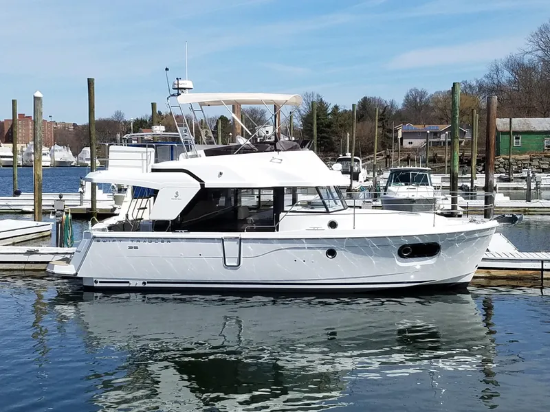 Slide: The Image of 2019 Beneteau Swift Trawler 35 docked at a marina, showcasing sleek design and modern features. - 4
