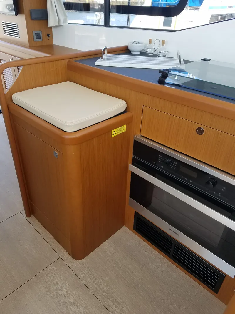 Slide: The Image of 2019 Beneteau Swift Trawler 35 kitchen area with stove and seating. - 41