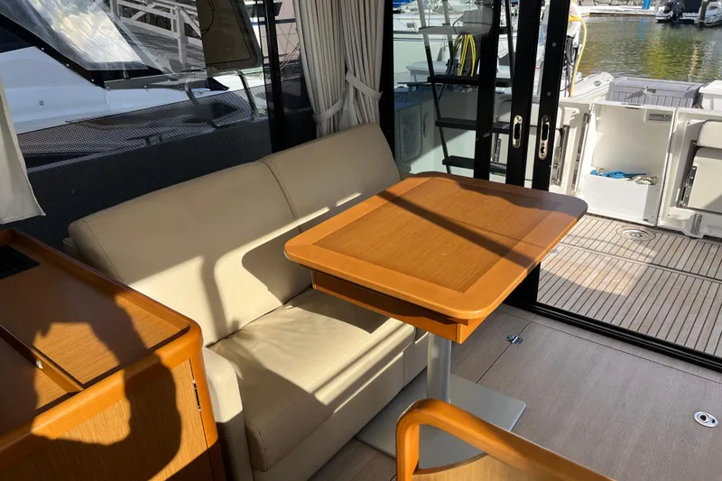 Slide: The Image of Interior of 2019 Beneteau Swift Trawler 35 with sofa and wooden table. - 45