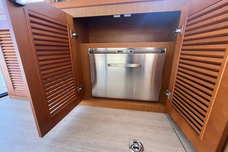 Slide: The Image of 2019 Beneteau Swift Trawler 35 interior with stainless steel appliance in wooden cabinet. - 47