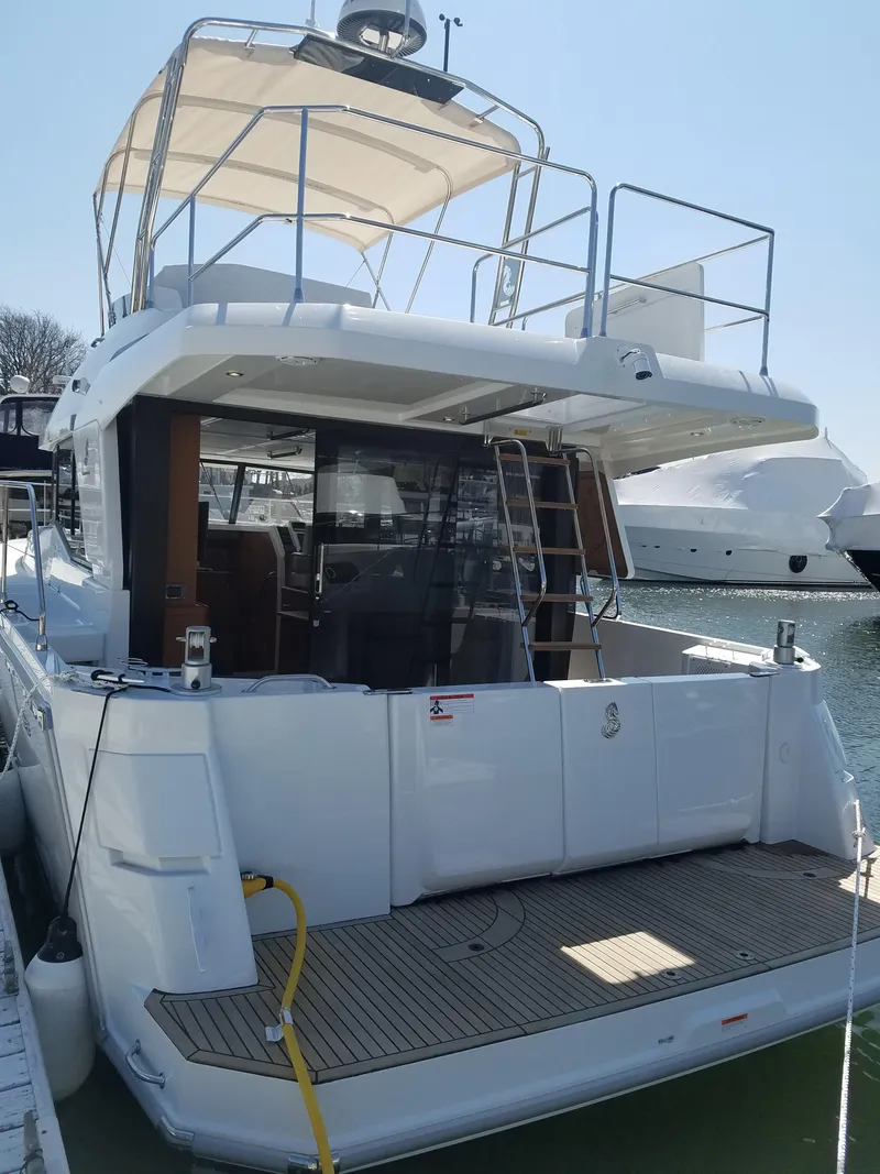 Slide: The Image of 2019 Beneteau Swift Trawler 35 docked, showcasing spacious deck and modern design. - 5