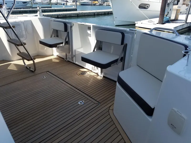 Slide: The Image of 2019 Beneteau Swift Trawler 35 cockpit with foldable seats and teak flooring. - 9