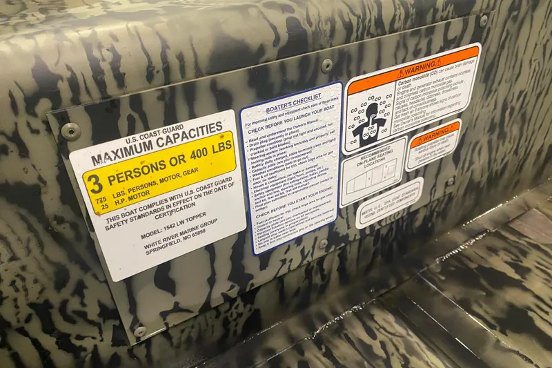 Slide: The Image of Safety and capacity labels on 2026 Tracker Grizzly 15 Jon boat interior. - 2