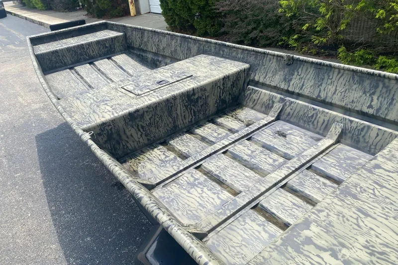 Slide: The Image of 2026 Tracker Grizzly 15 Jon boat with camouflage pattern on a street. - 4