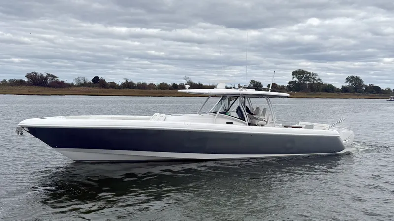 The Image of A 2019 Intrepid 475 Panacea on calm water. The boat features a sleek, modern design. - 0