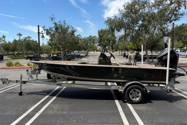 Slide: The Image of 2026 Mako 18 Pro Skiff Backwater Edition on trailer in parking lot. - 86