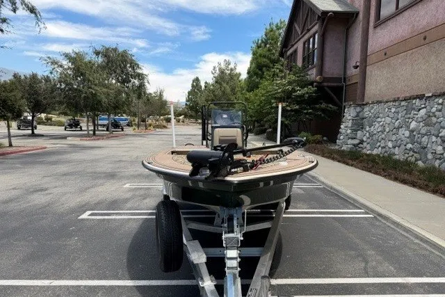 Slide: The Image of 2026 Mako 18 Pro Skiff Backwater Edition boat on trailer in parking lot. - 4
