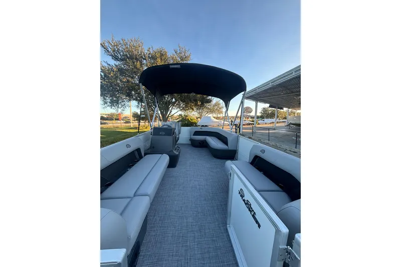 Slide: The Image of 2026 Sun Tracker Party Barge 16 DLX pontoon boat with spacious seating and canopy. - 2