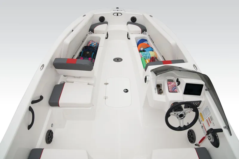 Slide: The Image of 2026 Tahoe T18 boat interior with seating and steering console, displayed in a showroom. - 9