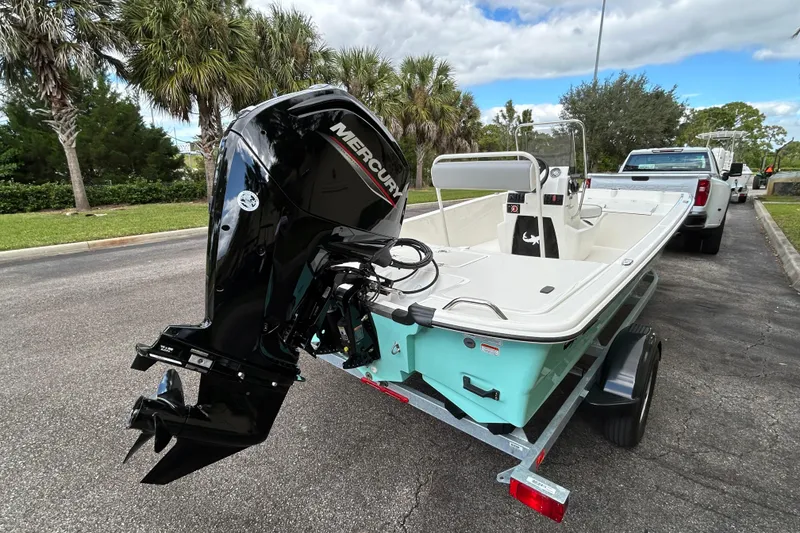 Slide: The Image of 2026 Mako Pro Skiff 17 CC boat on trailer with Mercury outboard motor. - 2