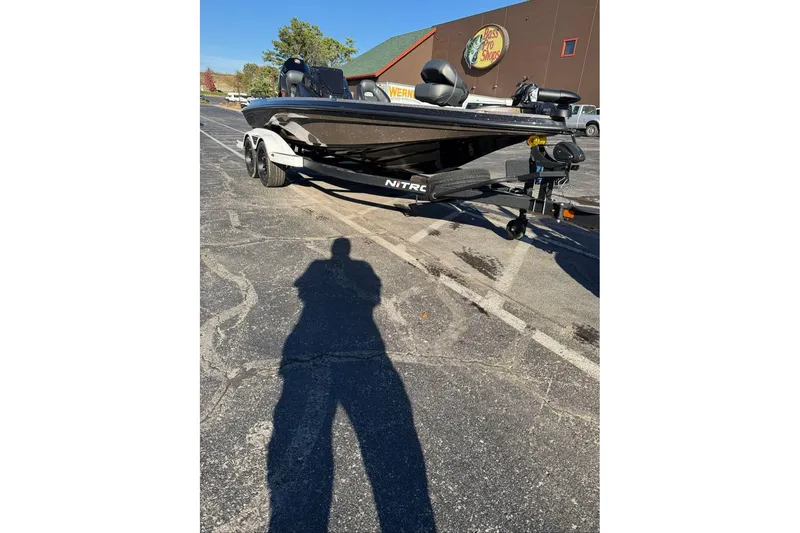 Slide: The Image of 2026 Nitro Z19 XL boat on trailer in parking lot, sunny day. - 94