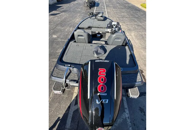 Slide: The Image of 2026 Nitro Z19 XL boat with Mercury 200 V8 engine, parked on pavement. - 93