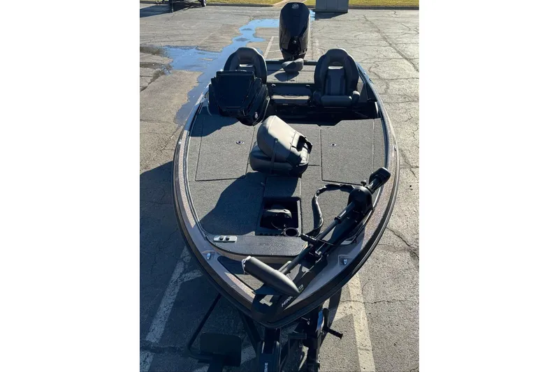 Slide: The Image of 2026 Nitro Z19 XL bass boat with seating and fishing equipment on a paved surface. - 92