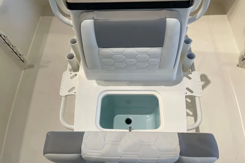 Slide: The Image of 2026 Mako 18 Pro Skiff boat seat with integrated storage and cup holders. - 7