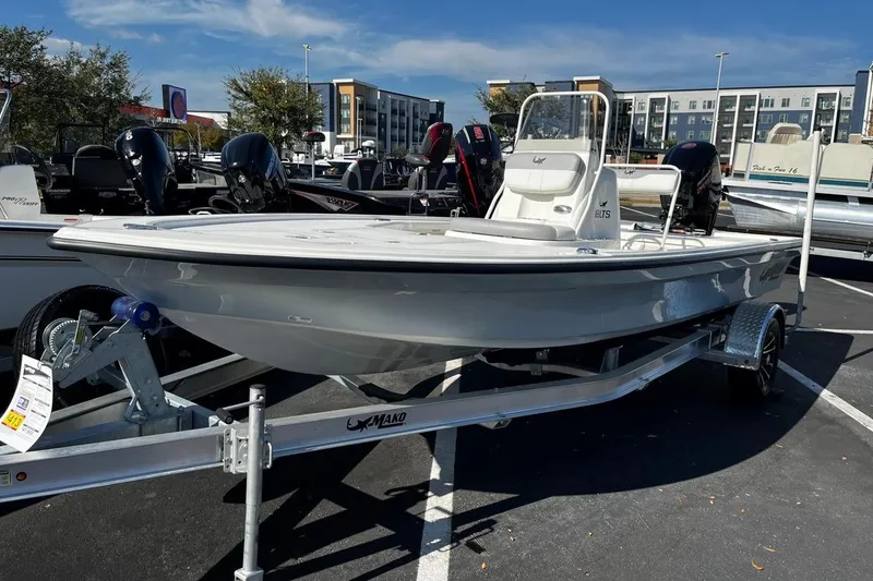 Slide: The Image of 2025 Mako 18 LTS boat on trailer in parking lot, sunny day. - 0