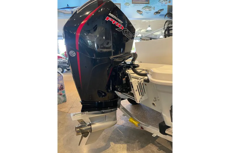 Slide: The Image of 2026 Mako 24 APEX boat with Mercury Pro XS outboard motor in showroom. - 13