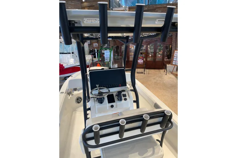 Slide: The Image of 2026 Mako 24 APEX boat interior with steering console and rod holders. - 5