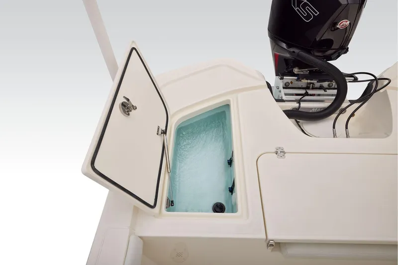 Slide: The Image of Open storage compartment on 2026 Mako 24 APEX boat, showcasing interior details. - 58