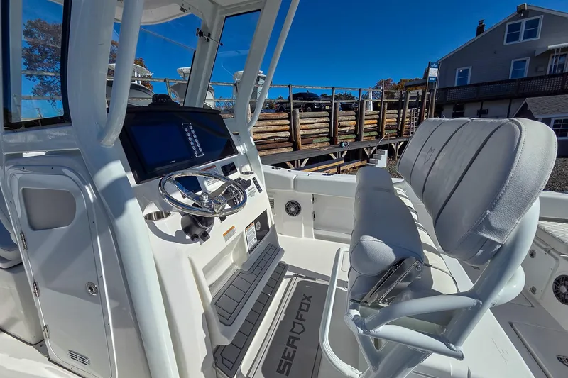 Slide: The Image of 2026 Sea Fox 268 Commander boat interior with steering wheel and seating. - 11