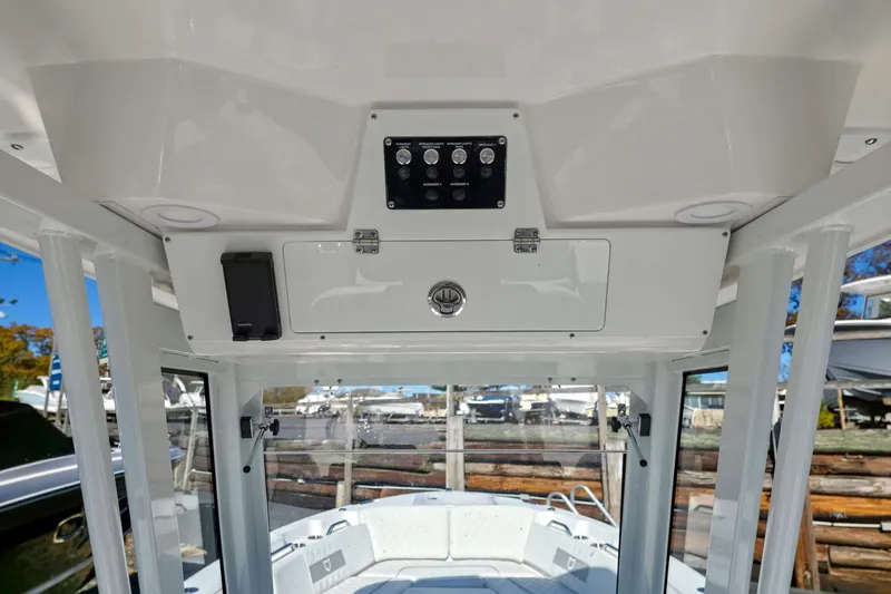 Slide: The Image of Interior view of 2026 Sea Fox 268 Commander boat, featuring control panel and storage compartment. - 14