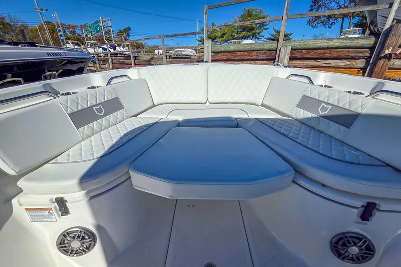 Slide: The Image of 2026 Sea Fox 268 Commander boat interior with white cushioned seating and cup holders. - 16