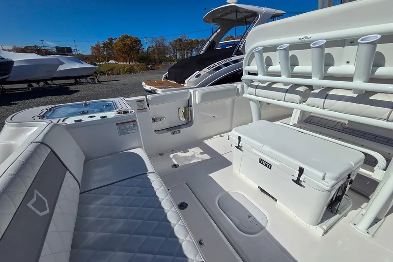 Slide: The Image of 2026 Sea Fox 268 Commander boat interior with seating, rod holders, and Yeti cooler. - 9