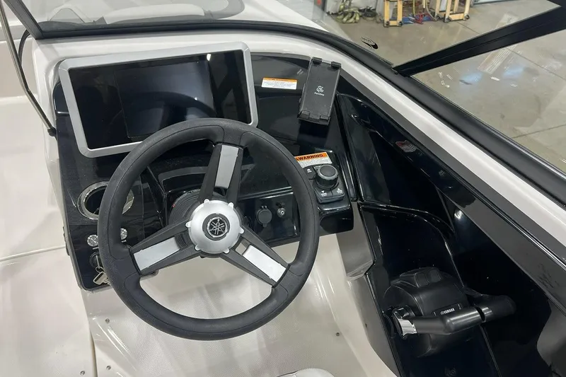 Slide: The Image of 2025 Yamaha AR250 boat dashboard with steering wheel and control panel. - 4