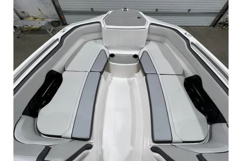 Slide: The Image of 2025 Yamaha Boats AR250 interior with sleek, modern seating and spacious layout. - 6