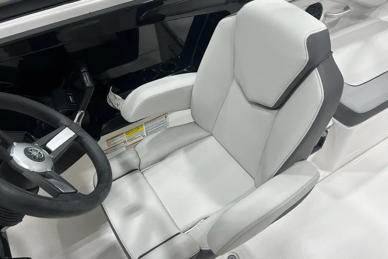 Slide: The Image of 2025 Yamaha Boats AR250 cockpit with sleek steering wheel and comfortable captain's chair. - 8