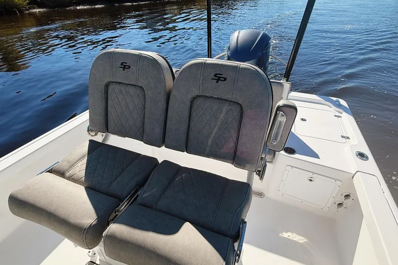 Slide: The Image of 2021 Sea Pro 248 Bay boat with dual cushioned seats on a sunny day. - 13