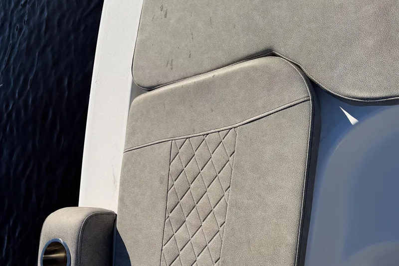 Slide: The Image of Cushioned seating on 2021 Sea Pro 248 Bay boat, featuring diamond stitching and cup holder. - 16