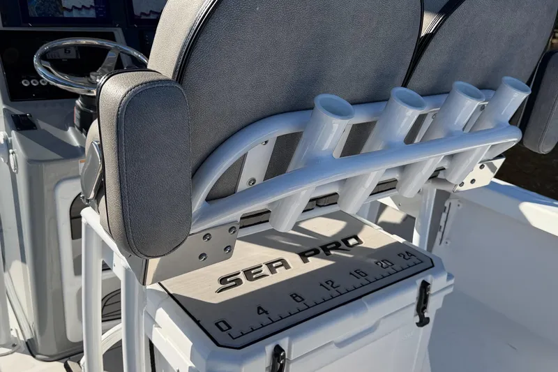 Slide: The Image of 2021 Sea Pro 248 Bay boat interior with rod holders and measuring board. - 19