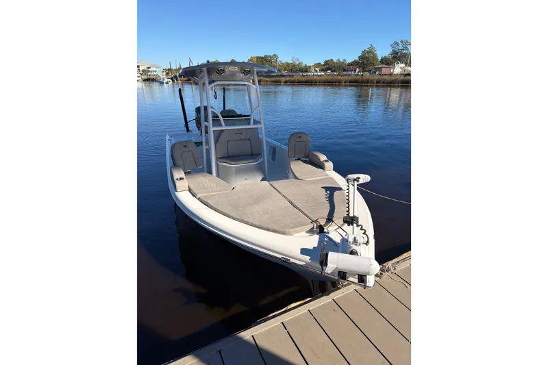 Slide: The Image of 2021 Sea Pro 248 Bay boat docked on calm water under clear blue sky. - 4