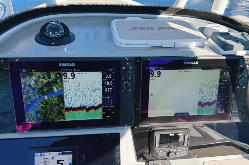 Slide: The Image of Dashboard of a 2021 Sea Pro 248 Bay boat with Simrad navigation displays. - 5