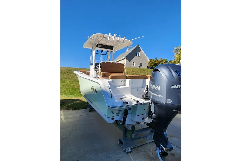 Slide: The Image of 2023 Sea Hunt Ultra 239 SE boat with Yamaha 300 engine, parked outdoors. - 3