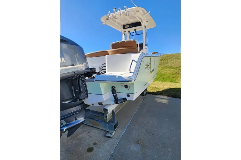 Slide: The Image of 2023 Sea Hunt Ultra 239 SE boat with Yamaha engine, parked on concrete. - 4