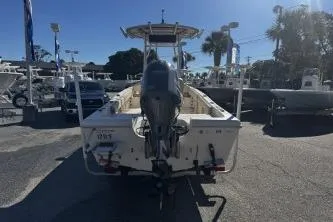 Slide: The Image of 2018 Carolina Skiff Ultra Series boat with outboard motor, parked in a marina. - 3