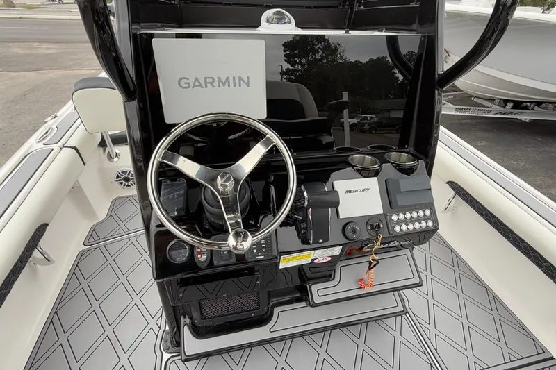 Slide: The Image of 2024 Tidewater 2500 Carolina Bay boat console with Garmin and Mercury controls. - 13